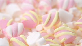 Marshmallow. Close-up of Marshmallows colorful chewy candy backdrop, rotation over pink background. Sweet food dessert in a cup with hot chocolate closeup. Dolly shot. 4K UHD video