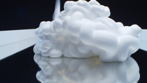 Close up of white cloud of shaving foam lying on mirror