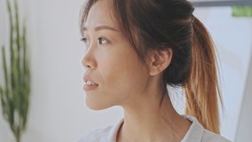 Cropped view of calm young asian business woman in her white office