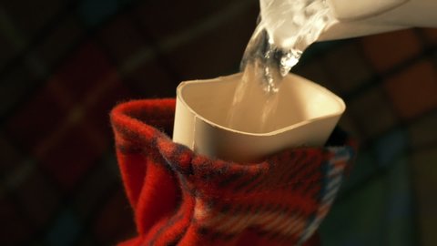 Kettle Pours Into Hot Water Bottle