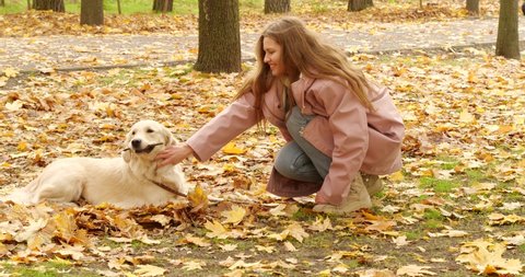Young woman with cute dog in autumn park