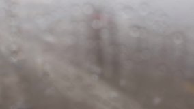 Footage of the city blurred out of focus background with cloudy gray spots