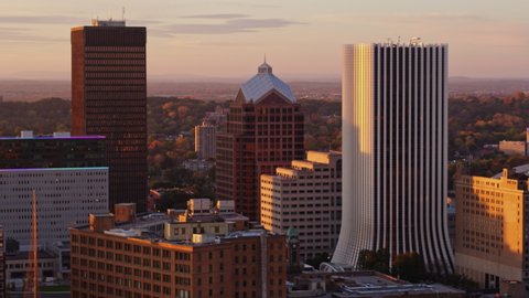 Rochester New York Aerial  Slow panning view of close up downtown skyline with river in backdrop at sunrise - October 2017