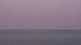 Red full moon rising over sea at sunset in a summer evening. 4k time lapse