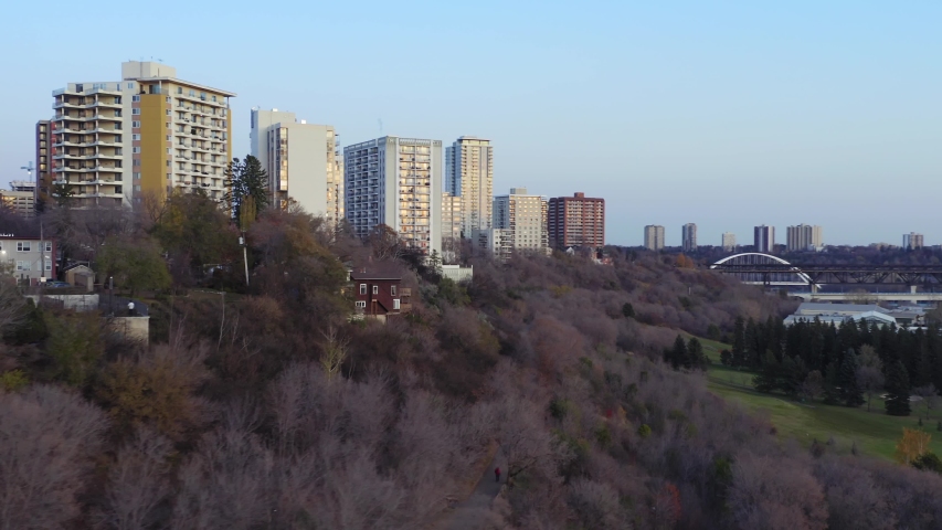 Aerial: Establishing shot of the Edmonton city skyline & apartment buildings at sunset. Edmonton, Alberta, Canada. 