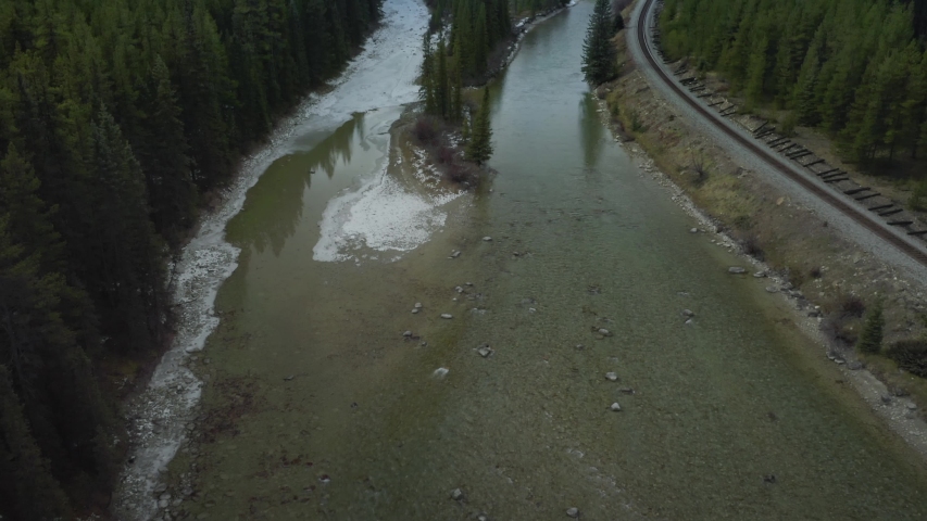 Aerial: Train tracks forest & river at Morant