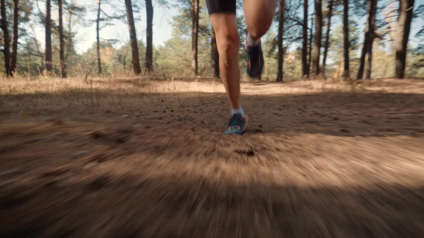 Running Man In Forest At Sunset. Runner Man Fit Athlete Legs Jogging On Trail Ready To Triathlon.Triathlete Running,Sprinting And Endurance Workout Training. Marathon Runner Jog On Trail.Sport Concept Royalty-Free Stock Footage #1041512572