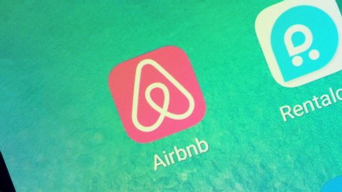 Macro of a Finger Touching Airbnb App on a Smartphone, in USA 2018