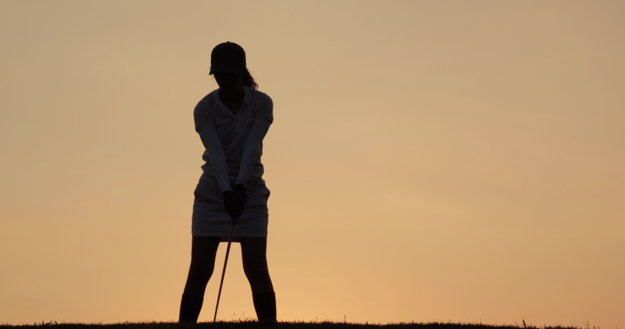 Professional golfer playing golf course with sunset background. People, sport, leisure activity, recreation and lifestyle concept. Slow motion shot.