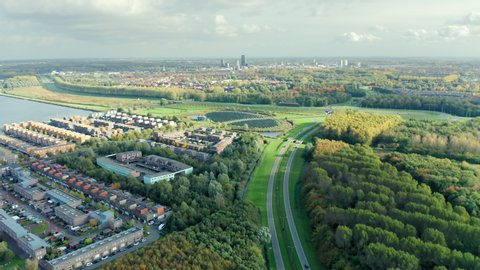 Modern sustainable residential neighbourhood Noorderplassen located close to nature. Aerial view with Almere city visible in the distance.