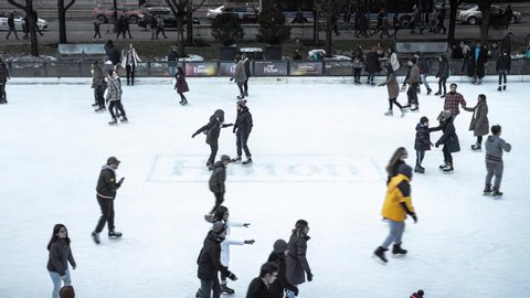 Chicago, IL - November 16th, 2019: Adults and children skate around the freshly opened McCormick Tribune Ice Rink in Millennium Park downtown which will remain open until March 8, weather permitting.