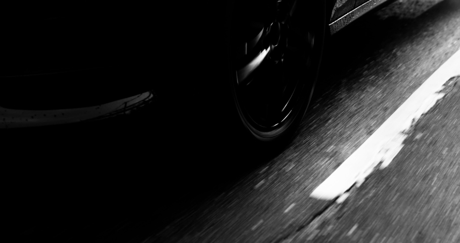 Reflecting everything around with its glossy surface, the premium car rides asphalt road where you can observe the suspension and how the tires perceive driving conditions. Black and white color  Royalty-Free Stock Footage #1041535441