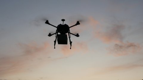 A Delivery Drone Transport Package, Sunset Silhouette