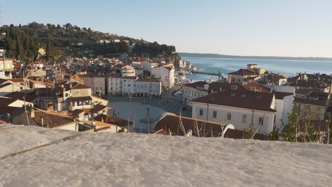 4k video. Camera moving shot. Central square with a monument and an ancient watch tower in Piran, Slovenia.
