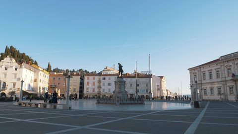 PIRAN,SLOVENIA ; APRIL 2019. 4k video. Camera moving shot. Central square with a monument and an ancient watch tower in Piran, Slovenia.