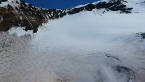 Kamchatka Peninsula, nature of Russia. The crater of active volcano Mutnovsky. Video shooting from a drone. UNESCO world natural and cultural heritage. The peak of the mountain