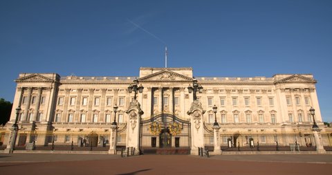 Front of Buckingham Palace in London, The Queen's official London residence home and a working royal palace feat. Union Jack flag flying over Buckingham Palace. 4K, empty, No people slow motion video 