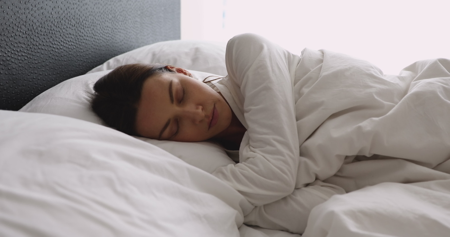 Disturbed annoyed young woman insomniac toss and turn lying awake in uncomfortable bed mattress on pillow in incorrect pose alone suffer from insomnia bad dreams problem trying can not sleep concept Royalty-Free Stock Footage #1041547591