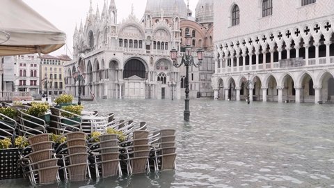 Saint Mark's square flooded, high tide affecting the beautiful church in Venice, Italy. 4k	Saint Mark's Basilica in Venice 