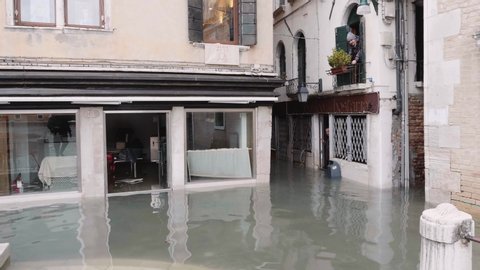VENICE, ITALY - November 13, 2019: Showcases of the closed stores during the flood in Venice, Italy. 4k