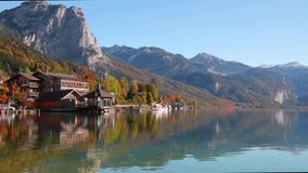 Bright sunny day on Grundlsee lake. Calm autumn view of Roslern village, Eastern Alps, Liezen District of Styria, Austria, Europe. Traveling concept background. Full HD video (High Definition).