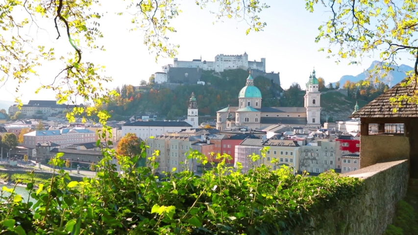 Bright cityscape of Salzburg, Old City, birthplace of famed composer Mozart. Sunny autumn scene of  Eastern Alps. Full HD video (High Definition).