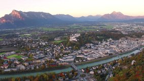 4k drone forward video (Ultra High Definition). Autumn cityscape of Salzburg, Old City. Great sunrise on Eastern Alps. Fantastic morning landscape with Salzach river. 