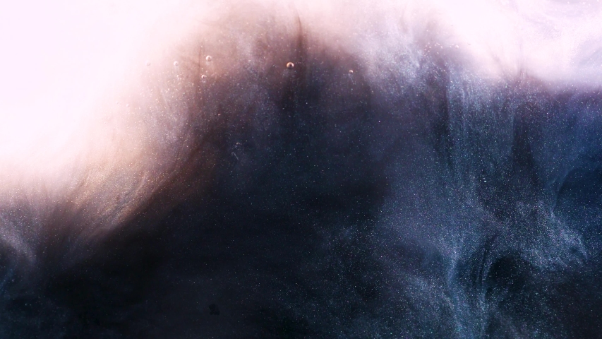 Abstract b roll footage mystical swirls of dark and light paint in the water, spangles like stars in space. The concept of movement, dynamics and mystical processes