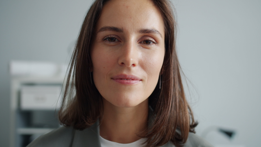 Close-up slow motion portrait of young business lady laughing in office smiling having fun looking at camera standing alone indoors. People and work concept. | Shutterstock HD Video #1041565348