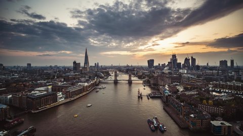 Establishing Aerial View shot of London Tower Bridge City Skyline Thames River Shard Great Britain United Kingdom slow track in drone helicopter during amazing sunset in May