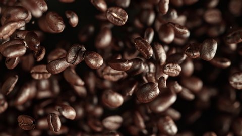 Super Slow Motion Shot of Exploding Premium Coffee Beans Towards the Camera at 1000fps.