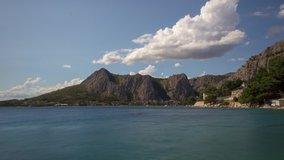 Omis Croatian city with sea and mountains time lapse with clouds and beach