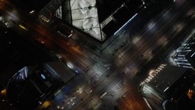 Top down night aerial view of road in the city center of Warsaw. Drone footage of skyscrapers and busy streets in Polish capital city