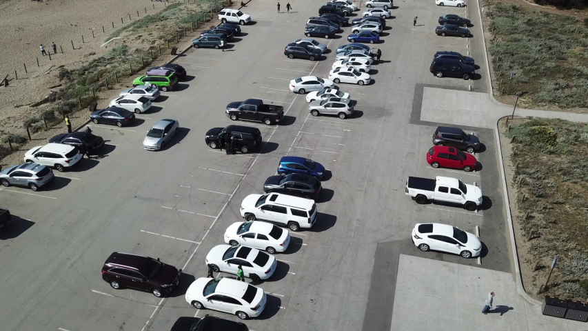 Aerial: Cars in a Baker Beach in San Francisco Across From the Golden Gate Bridge