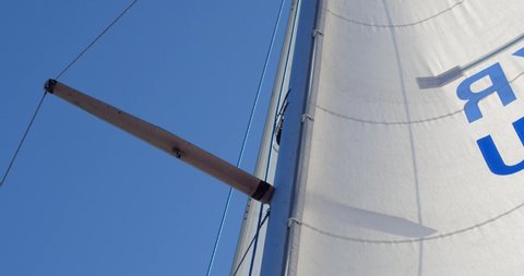 Yacht sail mainsail close-up, white, blue sky