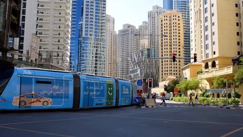 Dubai/UAE - November 11, 2019: View on JBR street intersection. Jumeirah Beach Residence. Dubai modern tram rides on the crossroad of JBR.