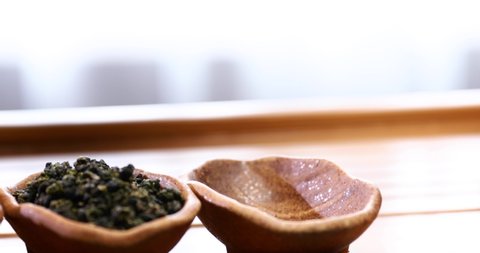 Dried tea leaves. Asian tea. Dried tea in porcelain jars. Footage 4K