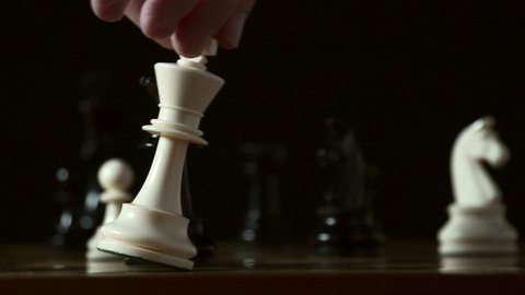 Defeat in slow motion -- chess player resigns by knocking over his king with his hand. Graceful, smooth slo-mo, shot at 240fps on the Sony FS700.