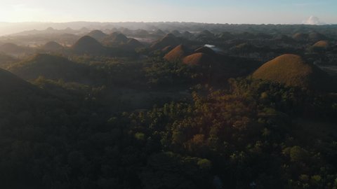 Chocolate Hills Surrounded With Nature at Sunrise Aerial View
