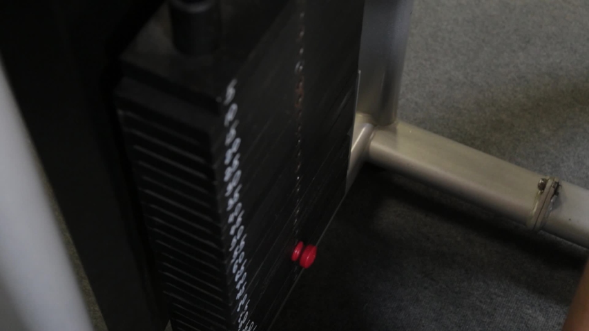 Strong athlete puts weight on a block simulator.