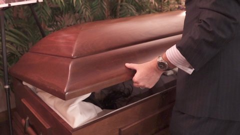 Funeral Director Man Closing Casket in Slow Motion. Coffin Closing at a Funeral