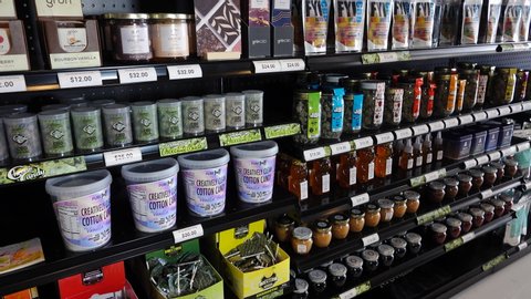 Pan of various CBD infused edible products on a shelf inside retail store. Photo taken in Vista, CA / USA - November 25, 2019. 