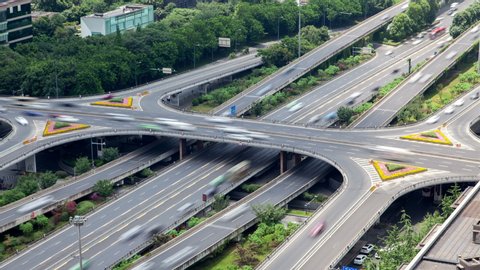 Timelapse cars drive along multi-lane Chengdu highways and overpass roads with interchanges and coloured flowerbeds on day in southwestern China Sichuan province