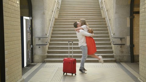 Young Couple Happy To Meet Again In The Train Station. Girl Runs To Meet Her Boyfriend.