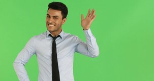 Portrait close up scene video of handsome Caucasian businessman wave his hand as a funny mood isolated on green background.