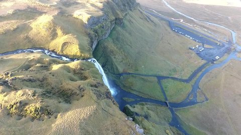 Aerial flight with drone over the famous Skogar waterfall in Iceland. It is located on the South of the island. Image taken with action drone camera causing distortion and blur. Slow motion shot
