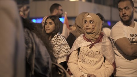BEIRUT DOWNTOWN, LEBANON - NOV 22, 2019: Several shots of supporters of the Lebanese Revolution celebrate Lebanon's Independence Day and sing national anthems