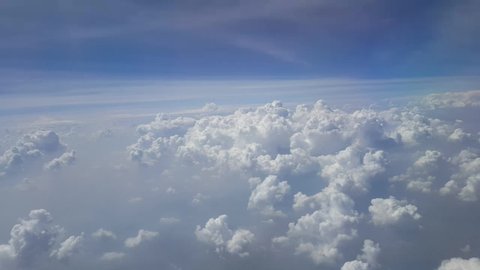 Airplane wing over blue sky and white cloud view looking through airplane window. Travel, vacation and journey concept.Soft focus,Select focus