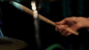Drummer playing the drums in a closeup on his hand