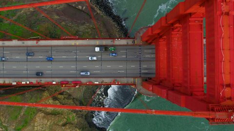 Traffic passing by the Golden Gate Bridge. San Francisco, US. Aerial view. It connects the San Francisco peninsula to Marin County. US route 101  and SR 1 full of cars. Shot on Red weapon 8K.
